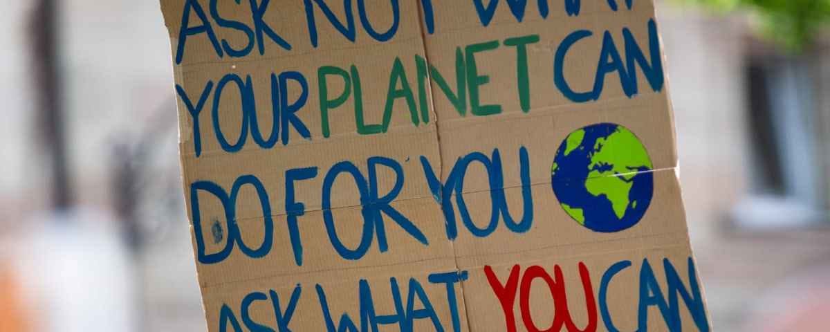 Earth Day 2022 sign saying, ”Ask not what your planet can do for you, ask what you can do for your planet.”