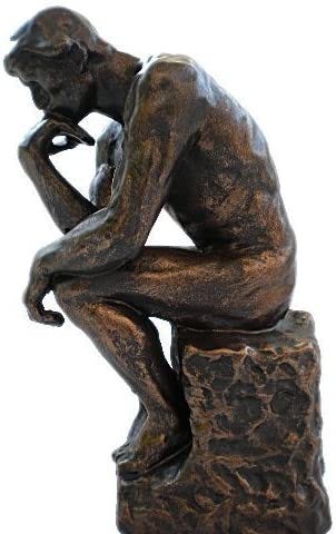 A statue of Rodin’s famous carving titled The Thinker: as a man sitting on a step leaning on his hand.