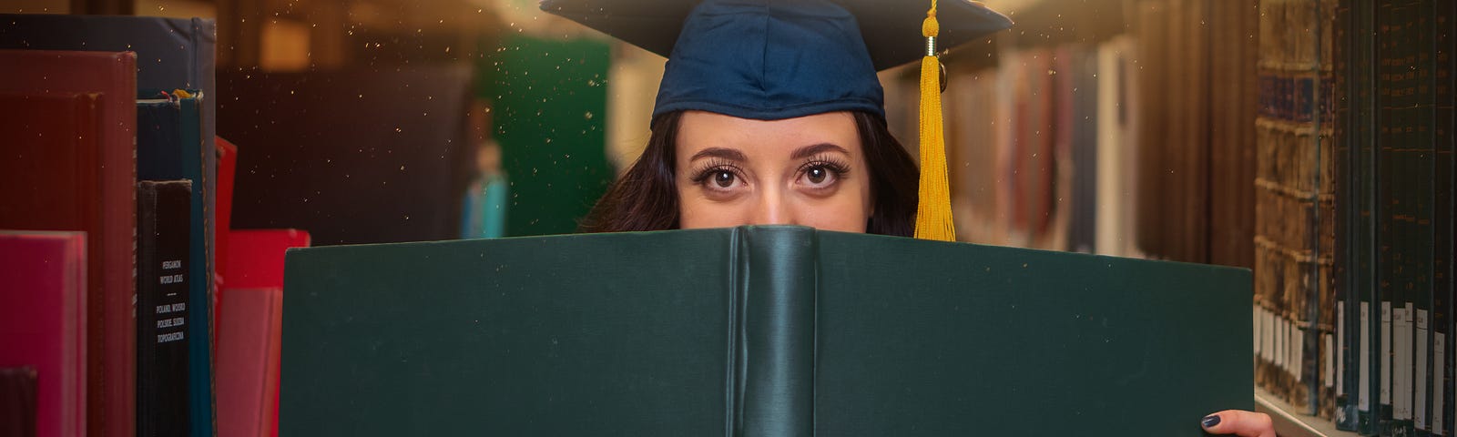 woman in library face half hidden by a book