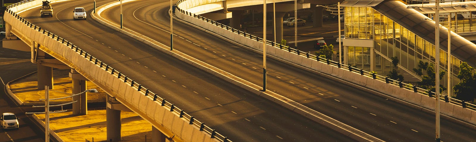 An empty highway overpass with only two cars on it