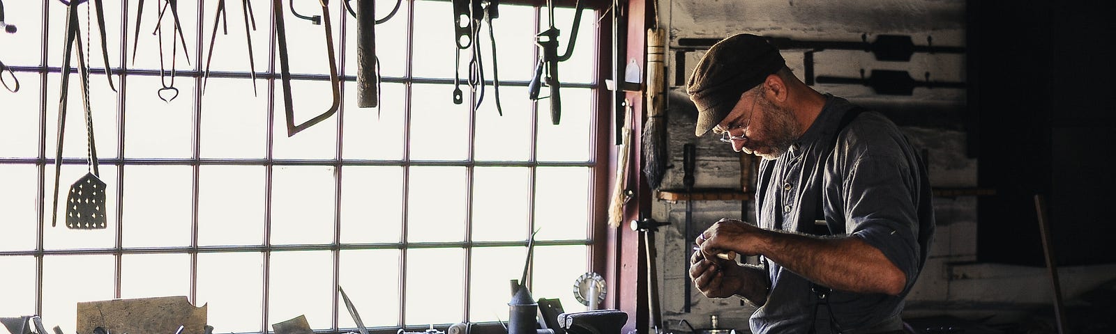 CRAFTSMAN AT WORK IN HIS SHOP