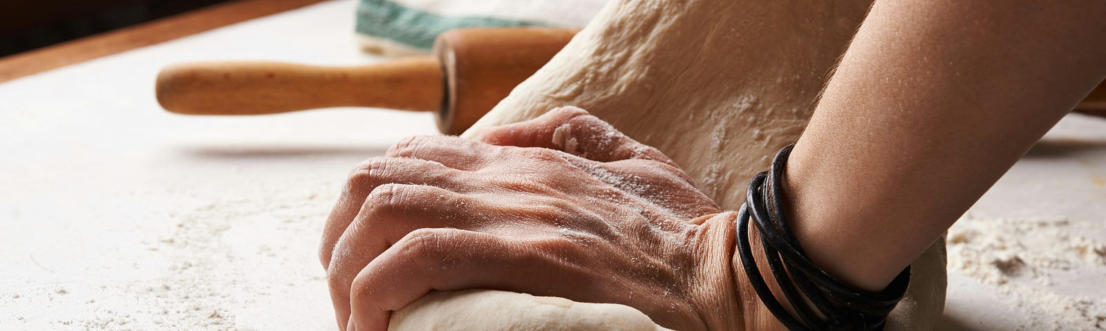 a woman kneading bread