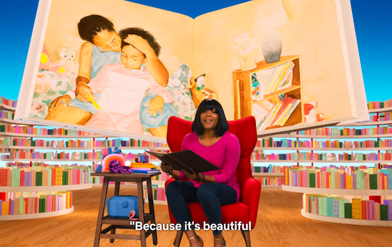 Screenshot showing Tiffany Haddish reading from the book with a large image from the book behind her.