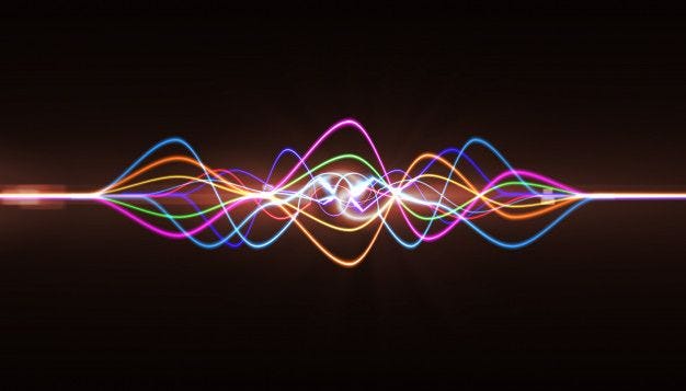 Multiple colored sound waves combined together, dark background