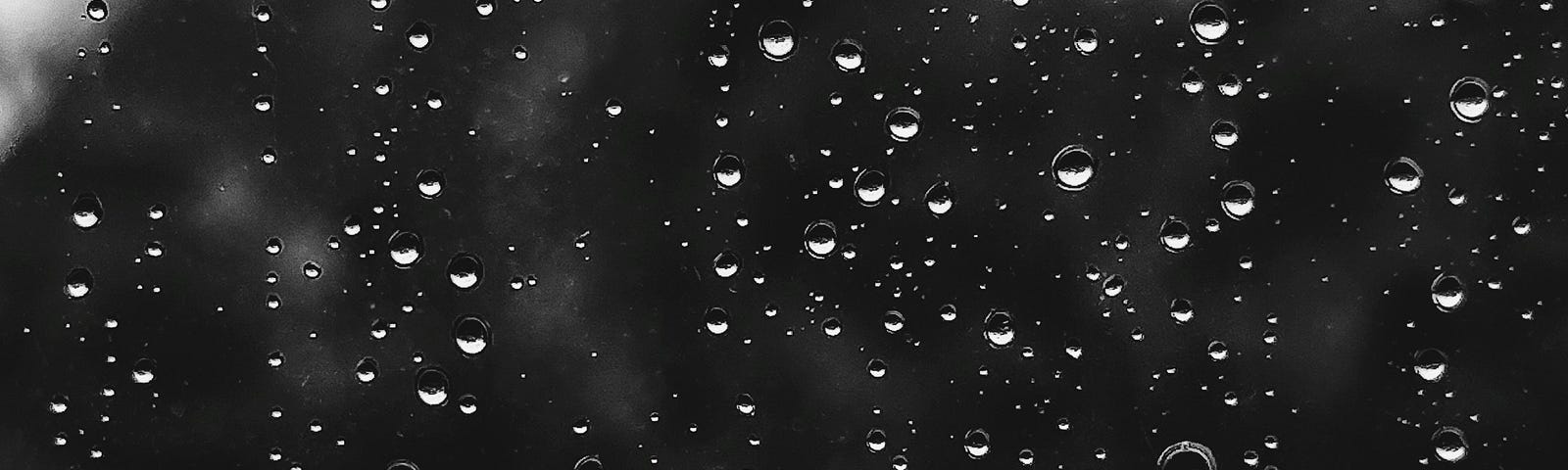 raindrops on a window, monochrome