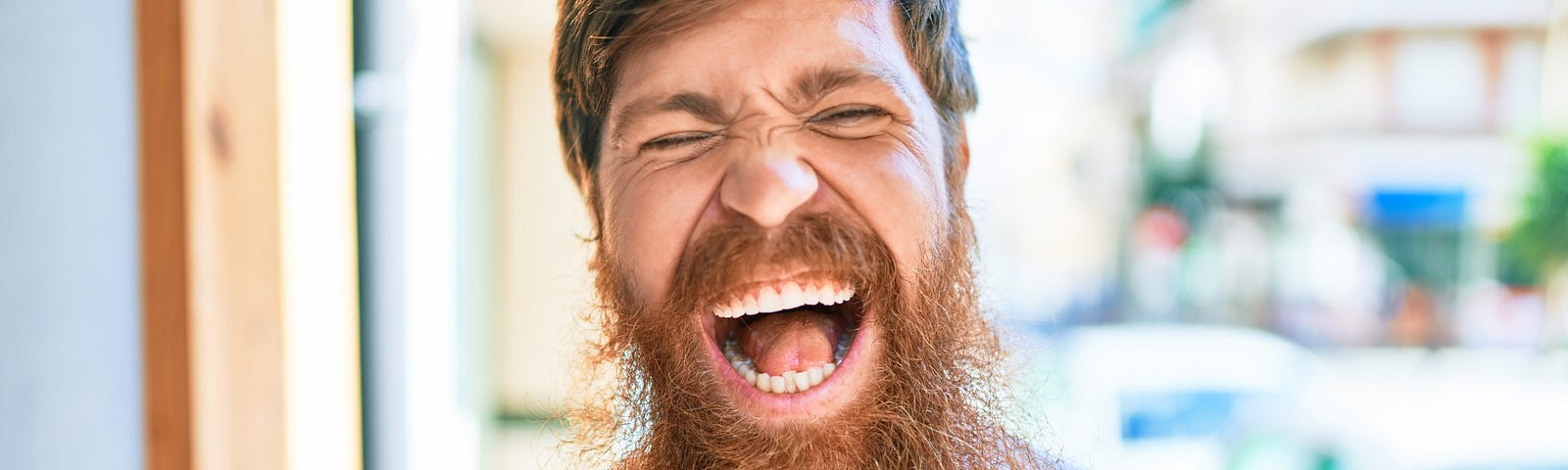 How to enjoy delayed gratification: Man with beard laughing