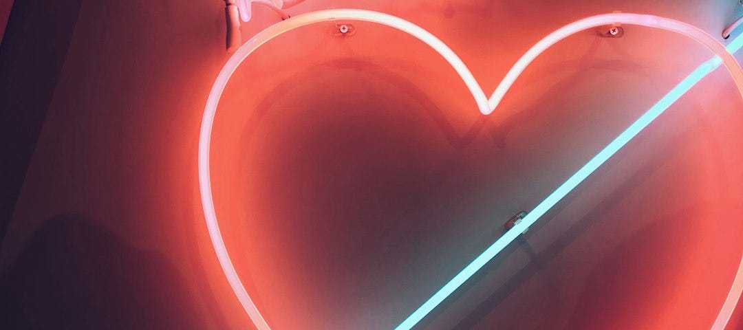 A neon sign showing a love heart