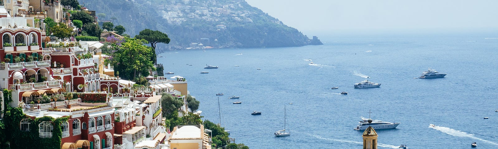 The Amalfi Coast, a hillside with colorful apartments overlooking boats on the water