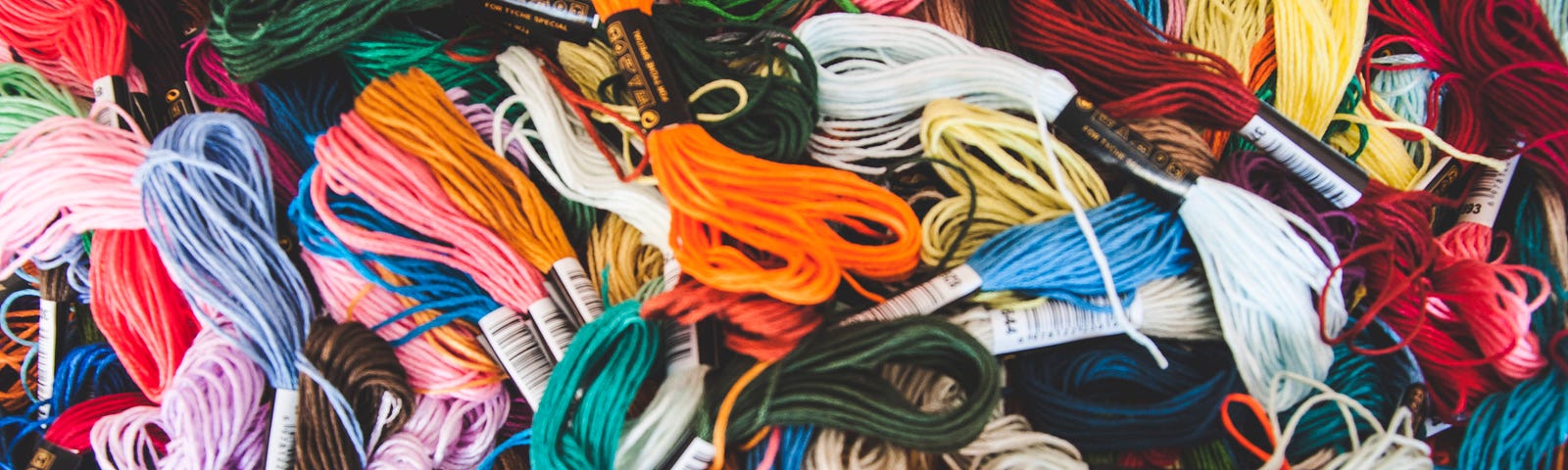 Many colors of embroidery floss, all in a pile