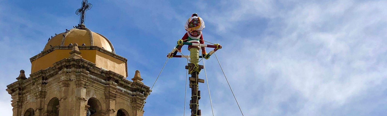 Four people being twirled on ropes high above the ground