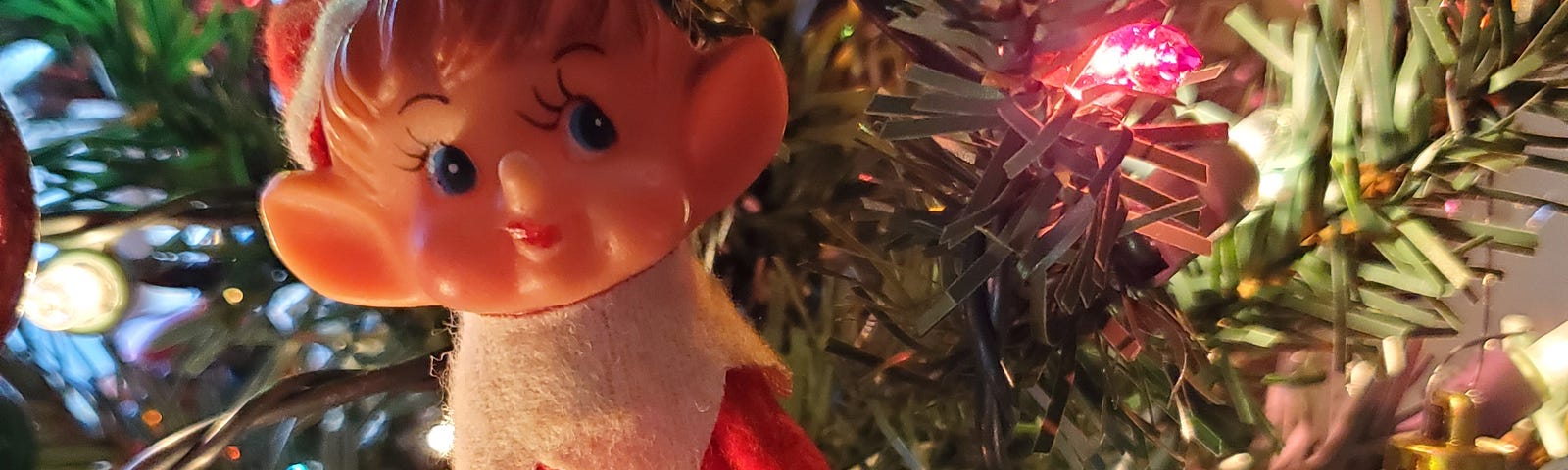 Elf in a lit Christmas tree