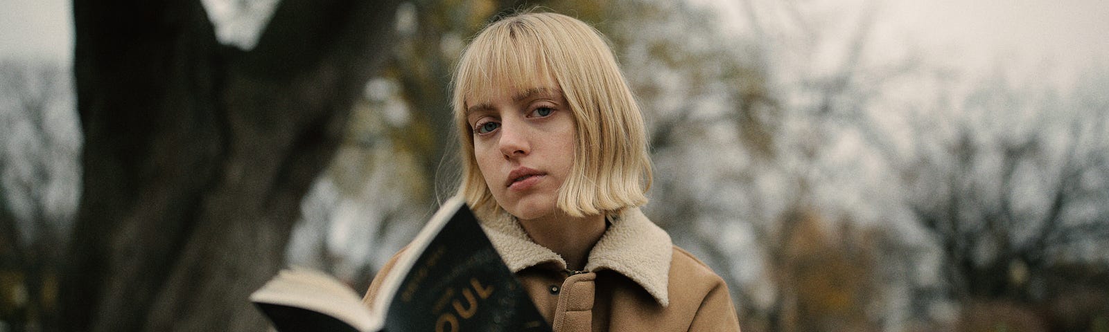 woman reading on a bench, compelling narrative