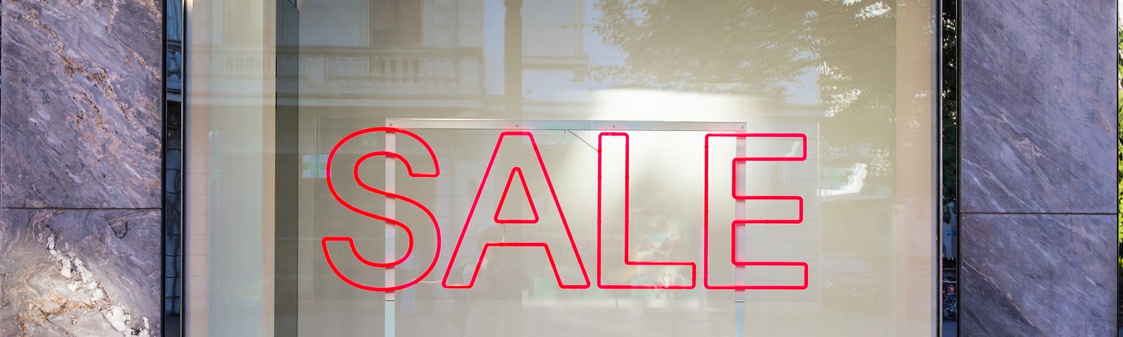 glass window with the word Sale in red letters