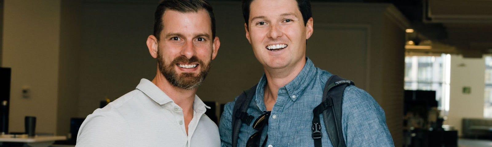 Tim stands side by side with Justin, our Chief Product Officer, both smiling at a company event.