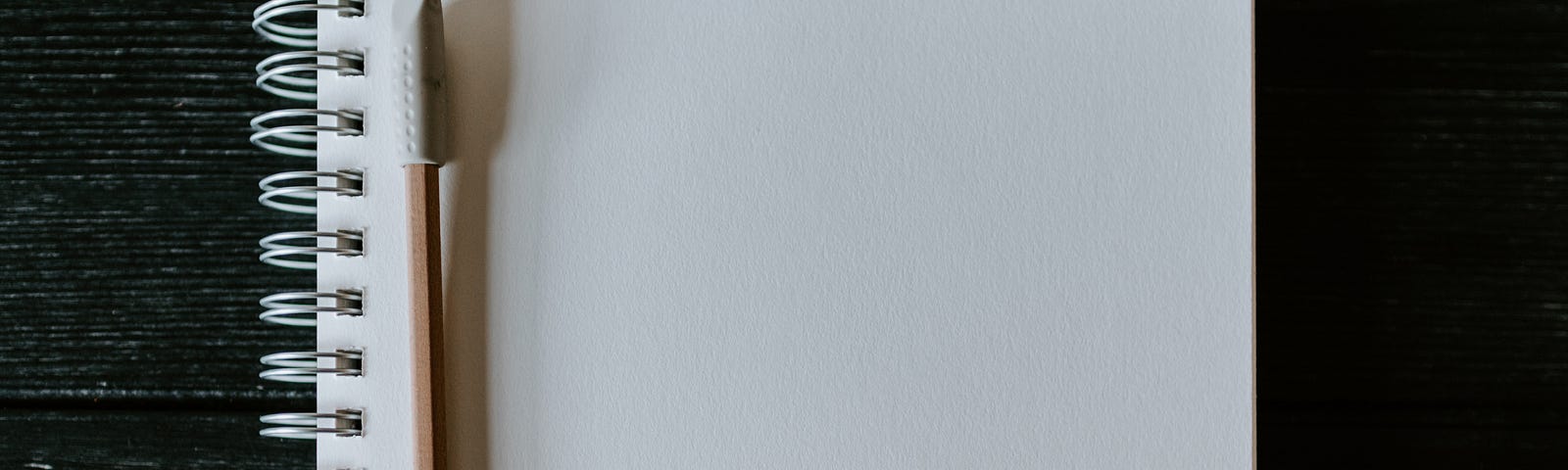 A blank page with a pencil beside it.