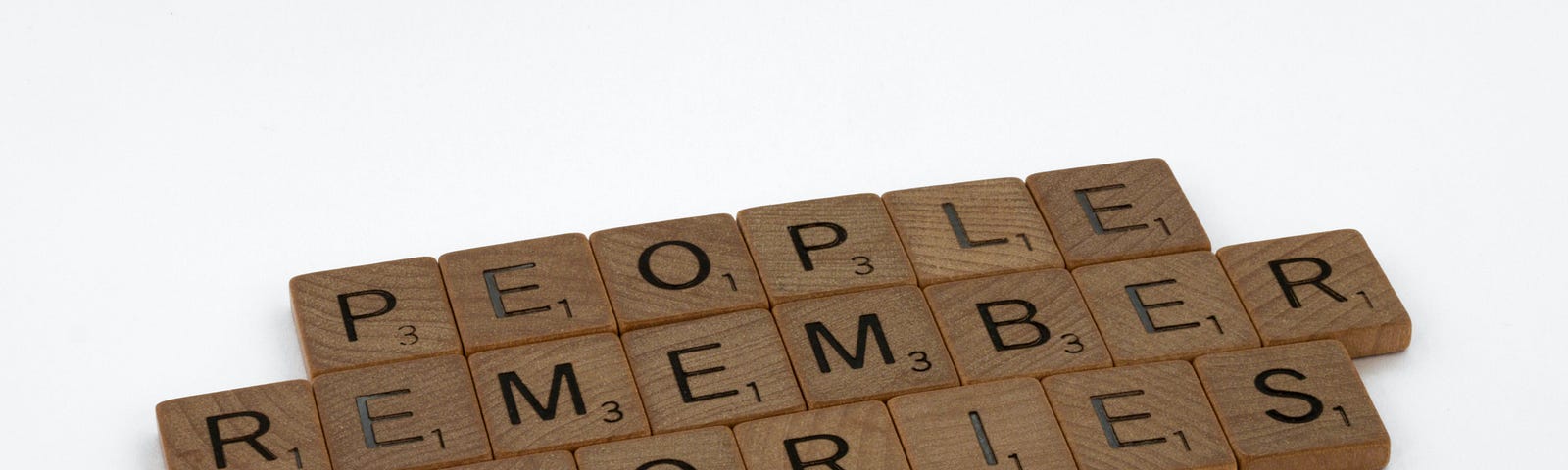 Scrabble tiles reading “People Remember Stories”