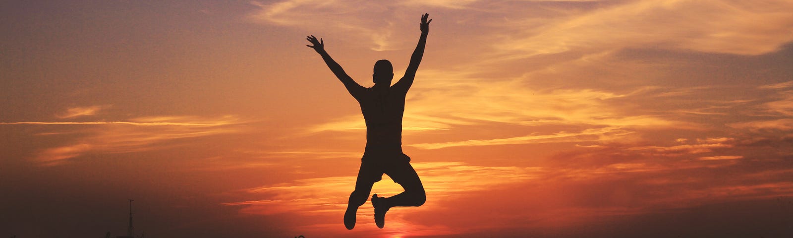 Man jumping as result of following the most direct path to happiness