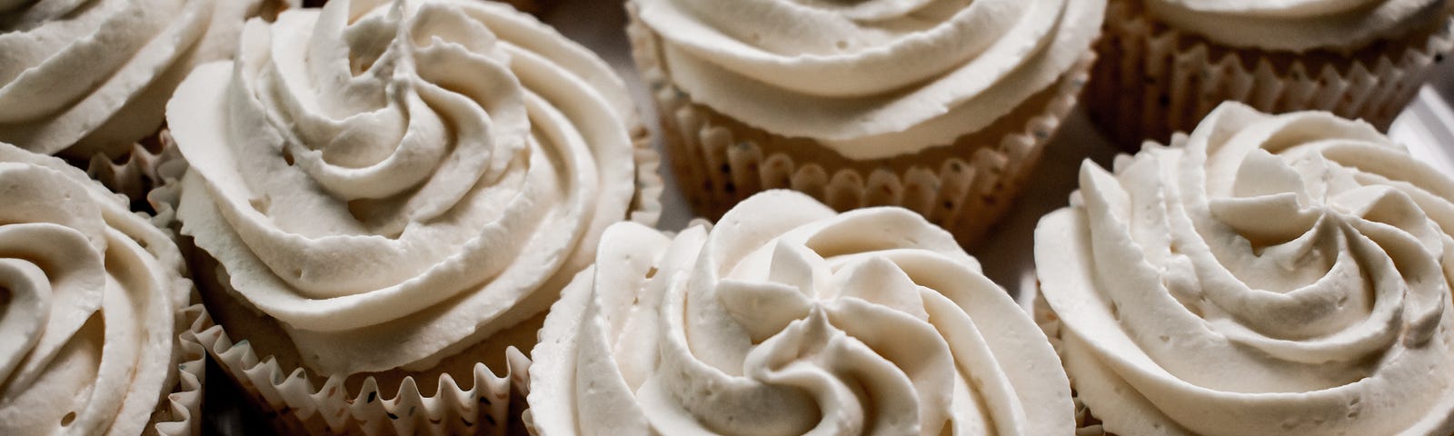 Beautiful pumpkin spice cupcakes with cream colored frosting. Unsplash.