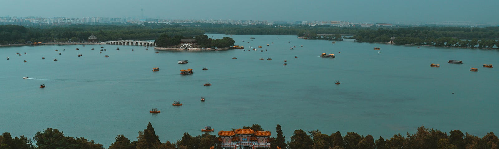 Overlook of a traditional Chinese palace with a body of water in front.