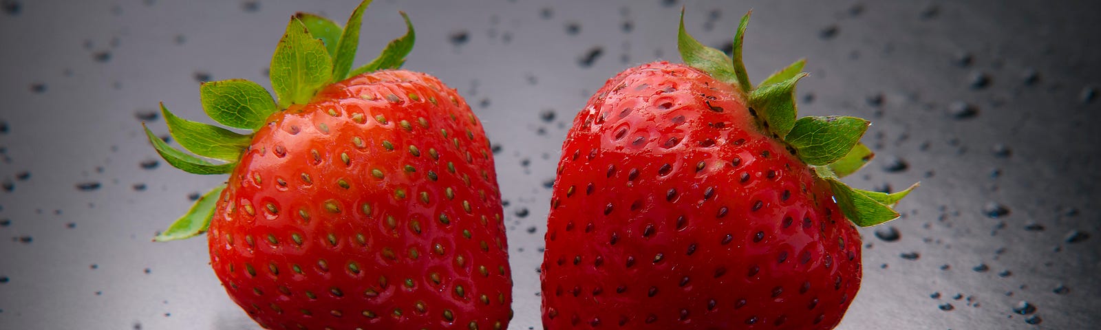 Two juicy looking strawberries.