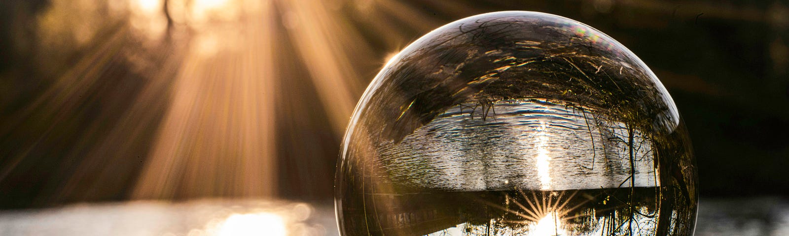 A crystal ball reflecting a serene lakeside scene with sunlight streaming through, symbolizing inner reflection and the perspective of finding freedom within.