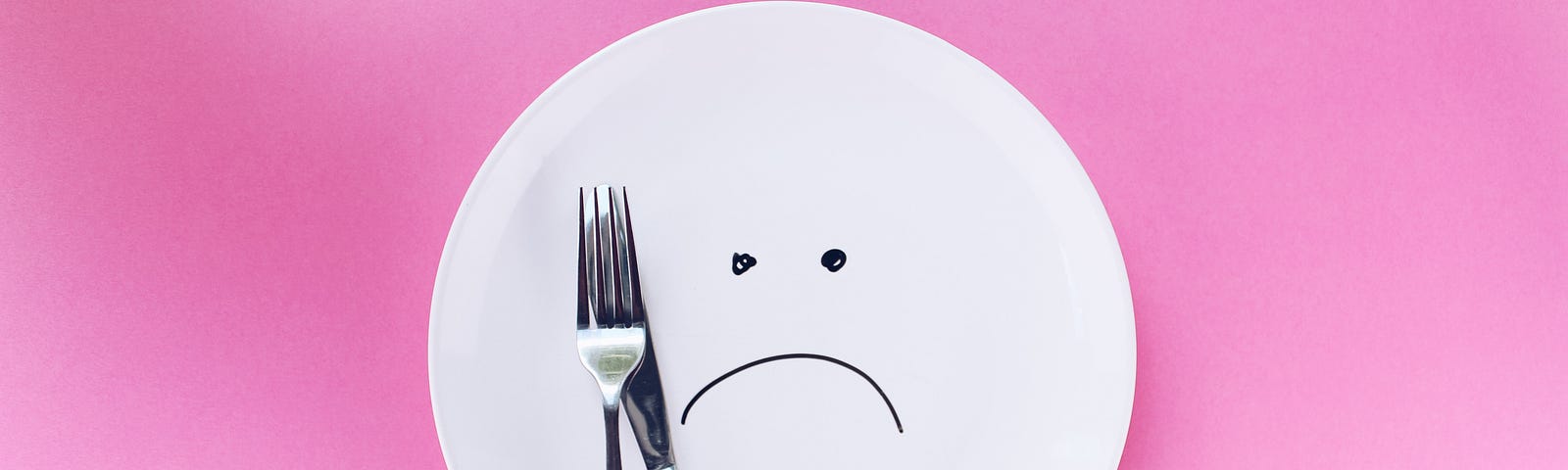 plate with frowning face drawn on it