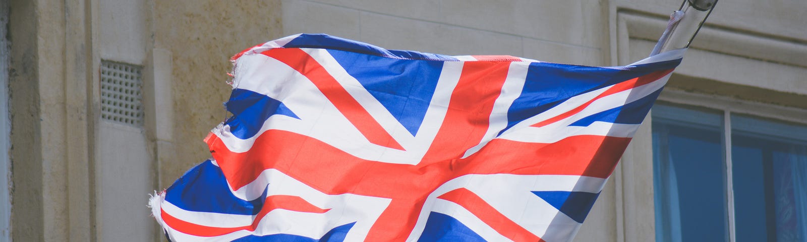A picture of the British flag blowing in the wind.