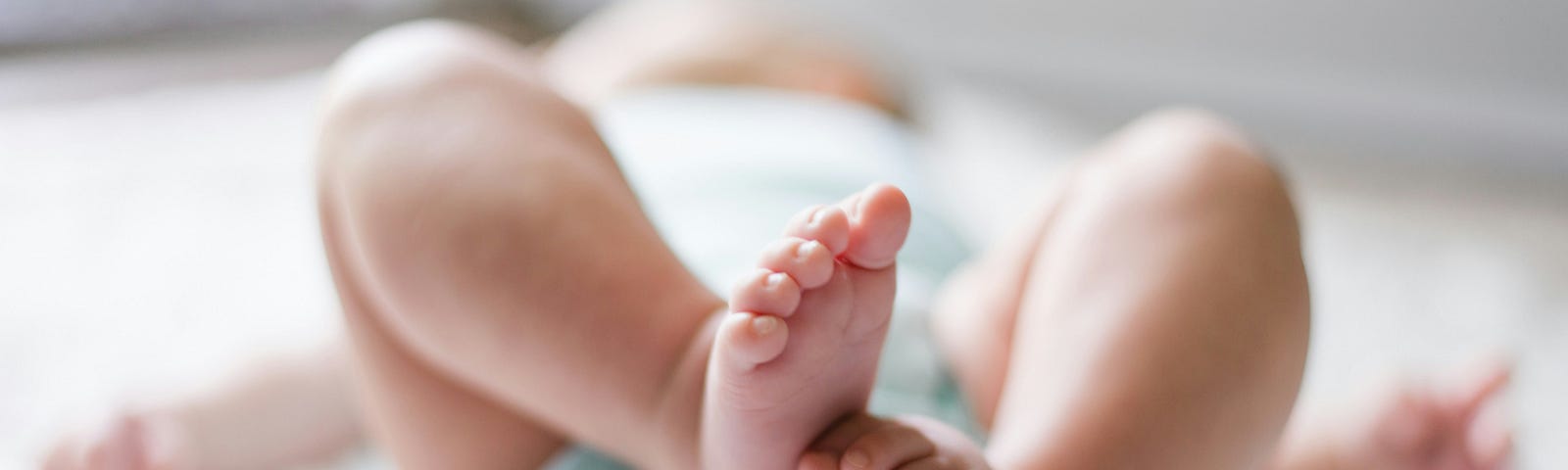 Curled up legs and feet of newborn baby