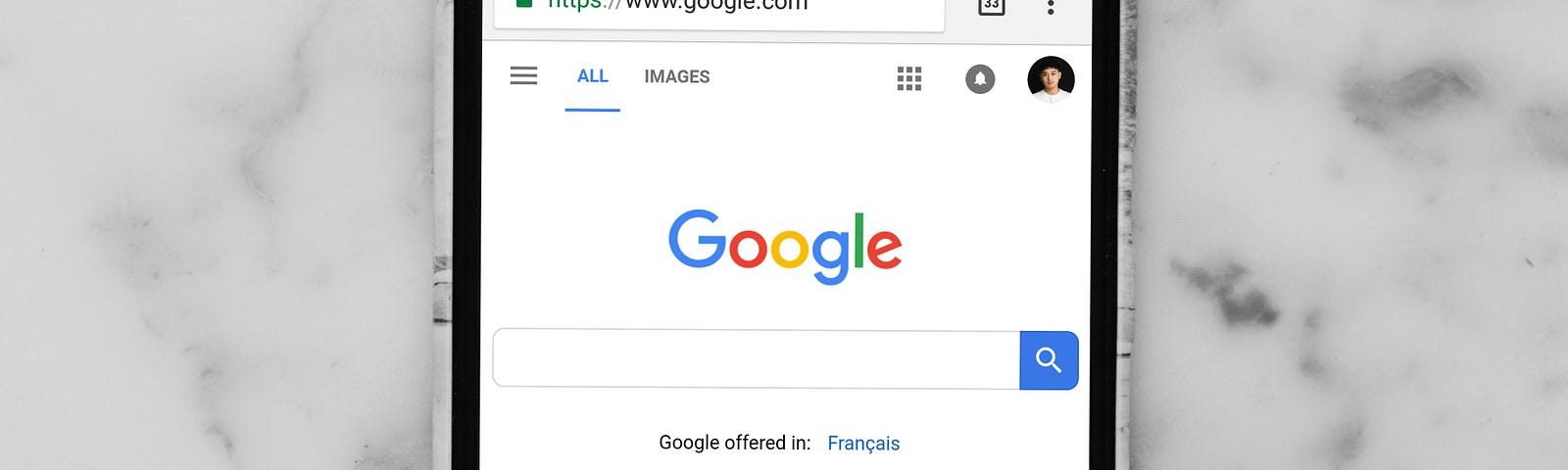 Photo of iPhone with Google Search open.