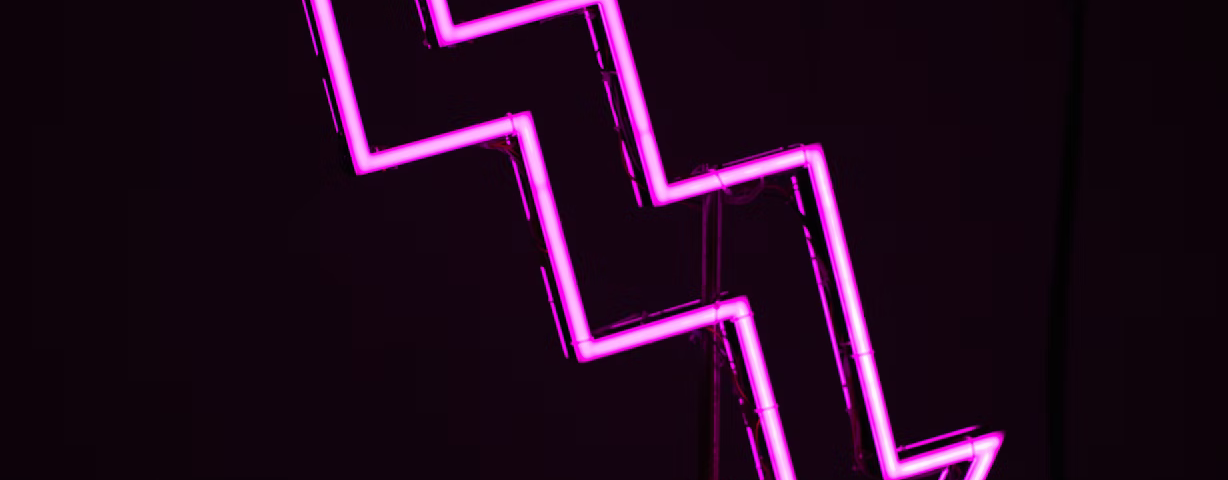 A purple arrow pointing downwards on a black background