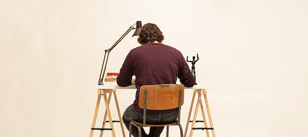 A man sits at a desk.