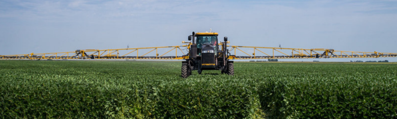 Crop sprayer moves across a field, Illinois
