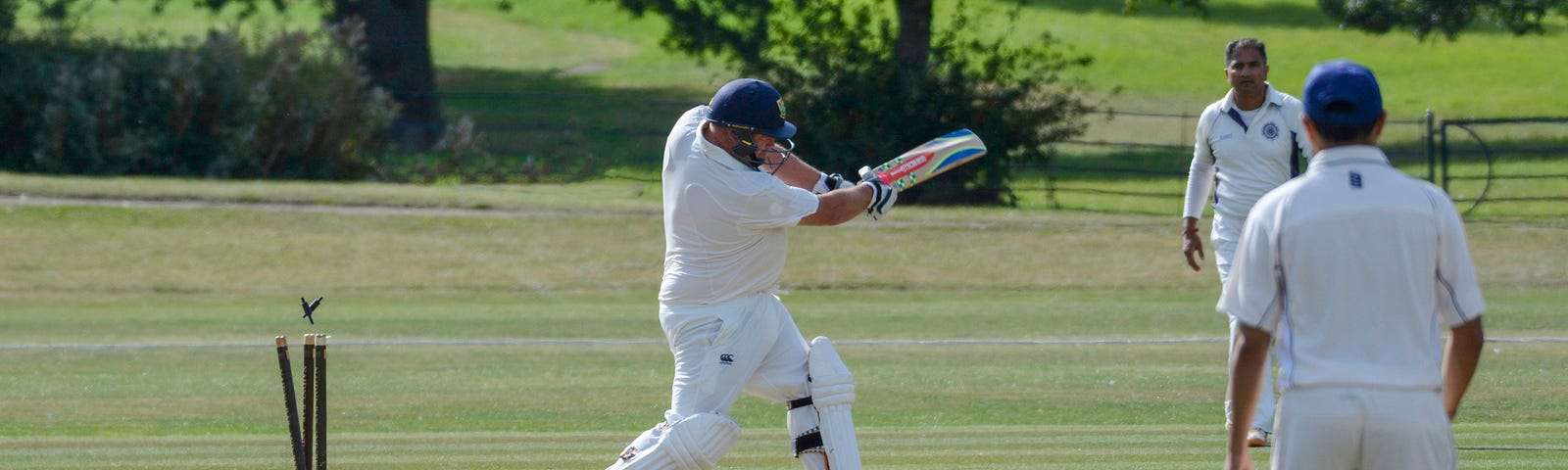 The Wickets have been clattered as the batsman misses the ball.