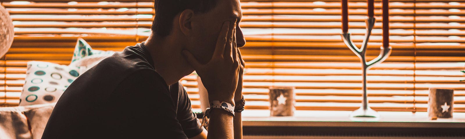 A man sitting on the couch — depressed.