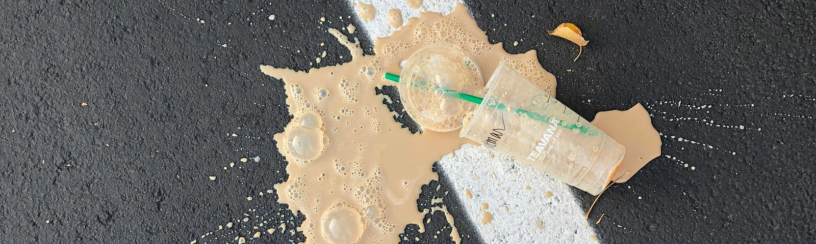 Iced coffee spilled on asphalt
