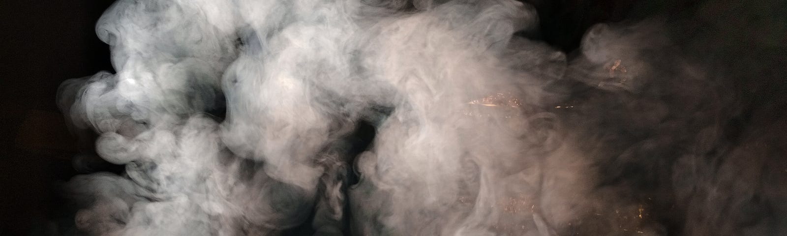 Grey smoke on a black background.