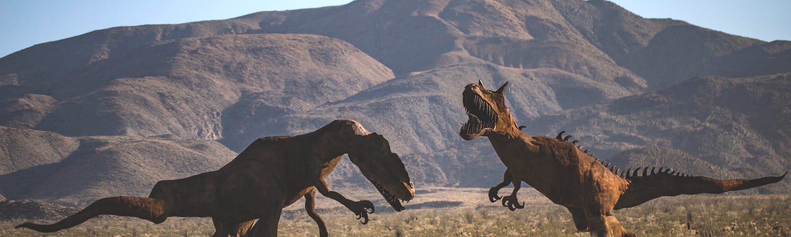 Two T-Rex dinosaurs fighting in a dessert landscape, with mountains behind