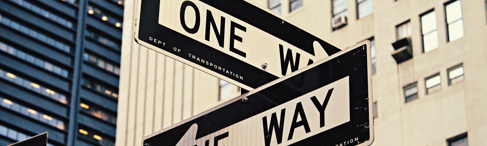 Street signs read “One Way” facing opposite directions