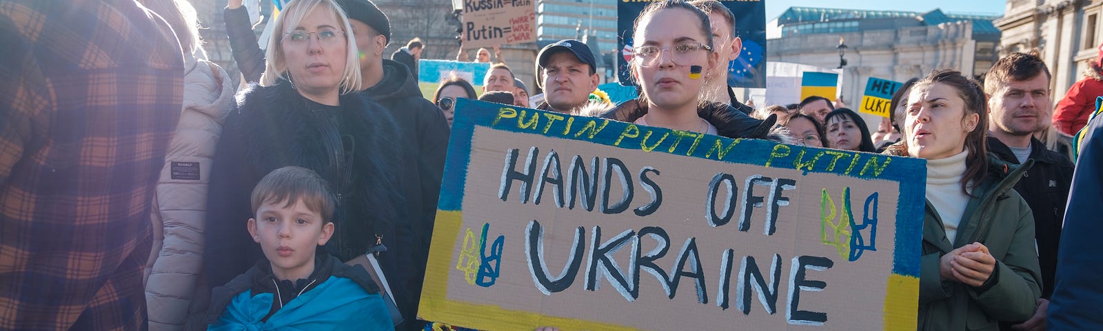 a large group of people take part in a demonstration against Putin’s invasion war