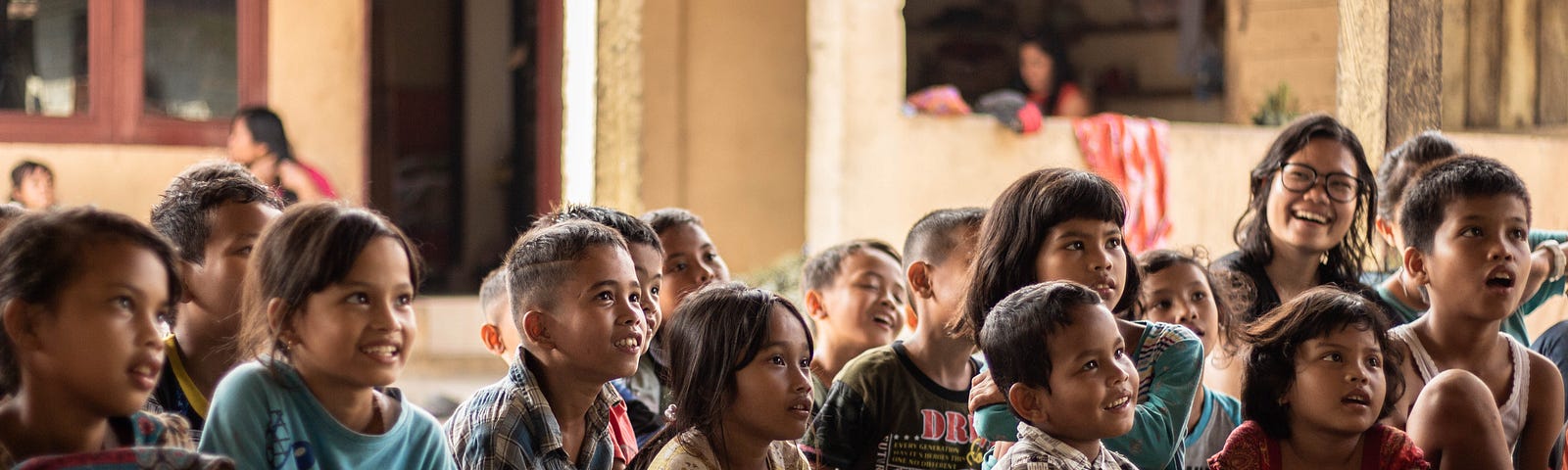 Kids in a group listening to a teacher