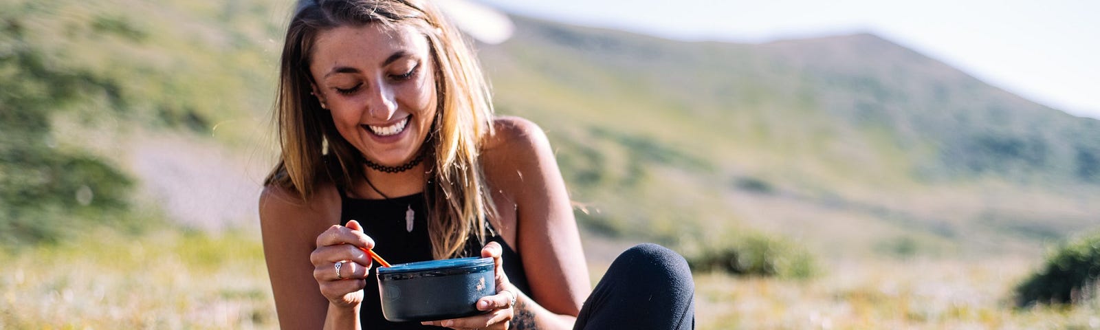 Woman sitting on the grass eating