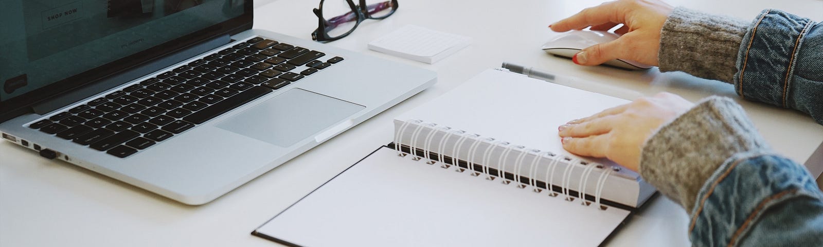 An organized desk with hands ready to work