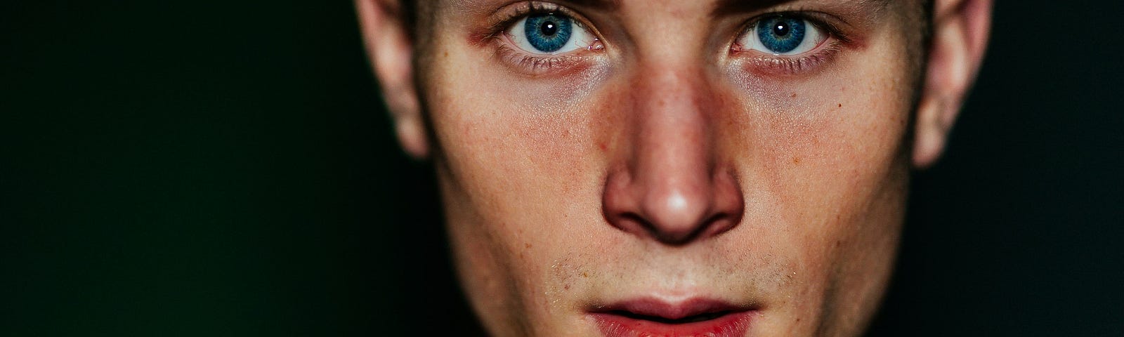 a young man with bright blue eyes