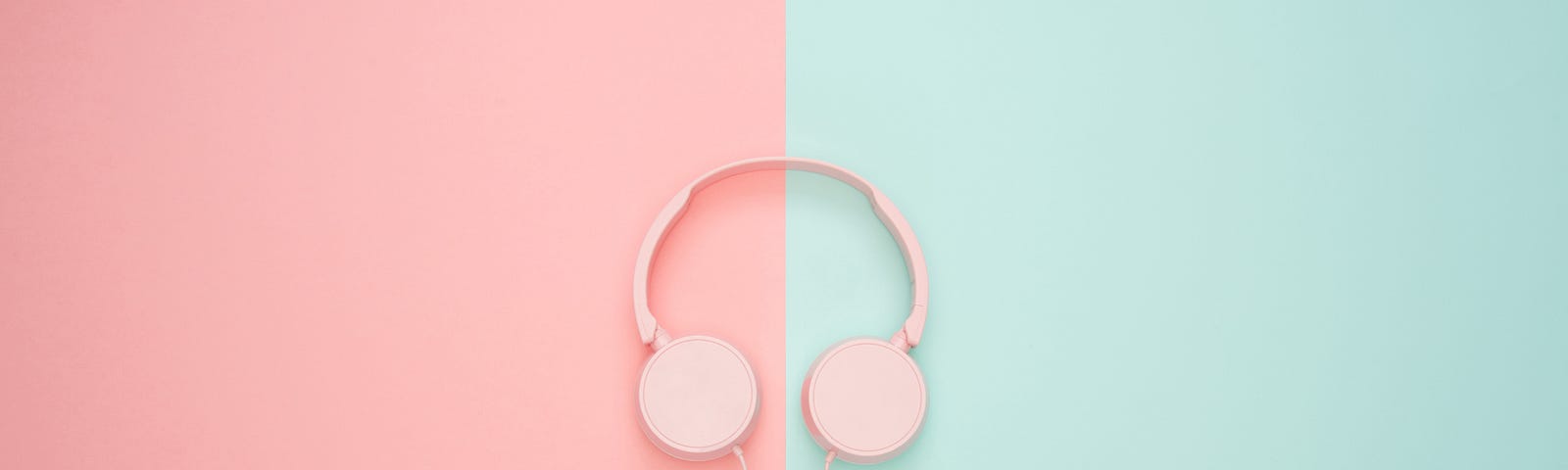 Pink headphones on a pink and blue background