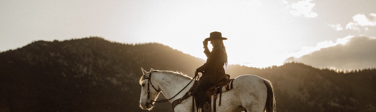 a single woman on horseback on the plains