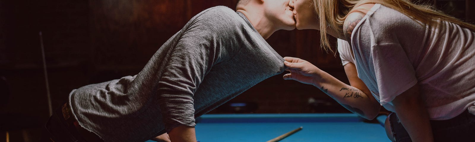 Couple kissing in a bar