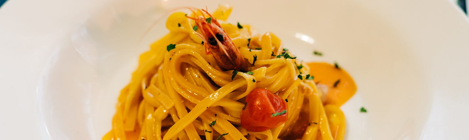 pasta tossed in light sauce with fresh tomatoes and basil.