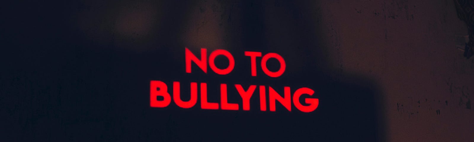 Image of a red light lit up that says “No to Bullying”.