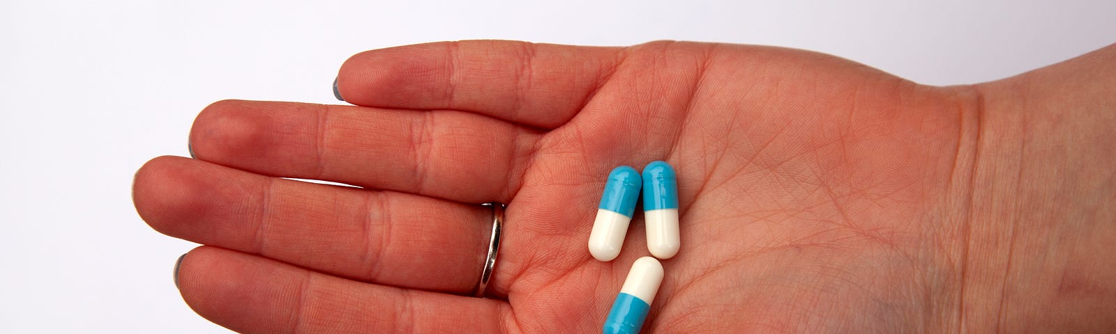 Hand holding medicine capsules