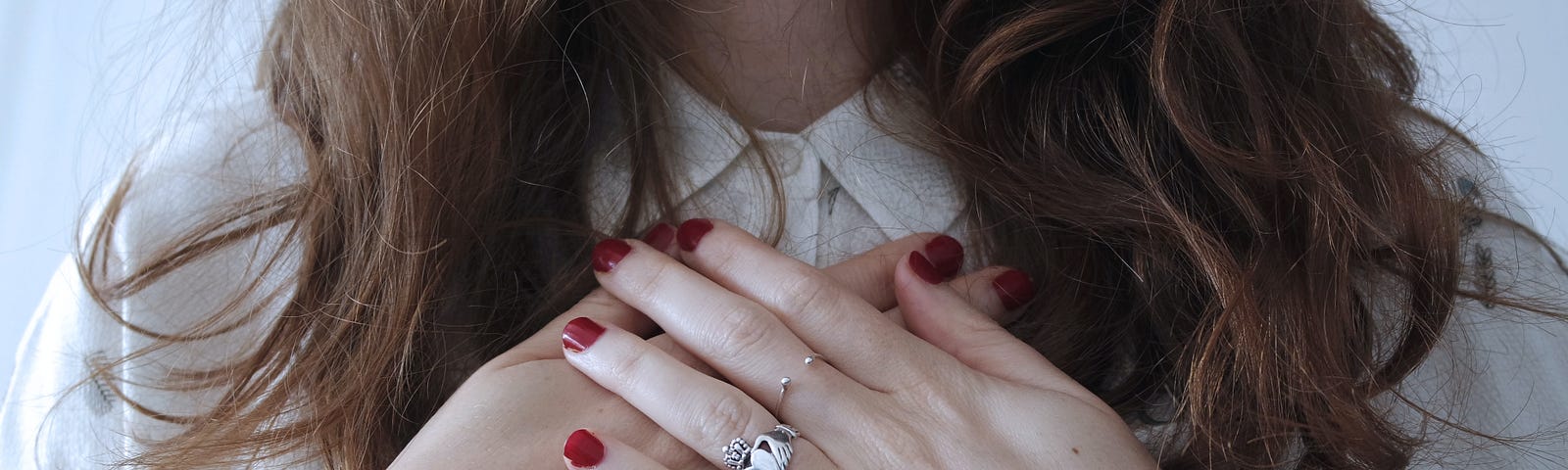 A girl placed her hands on her heart.
